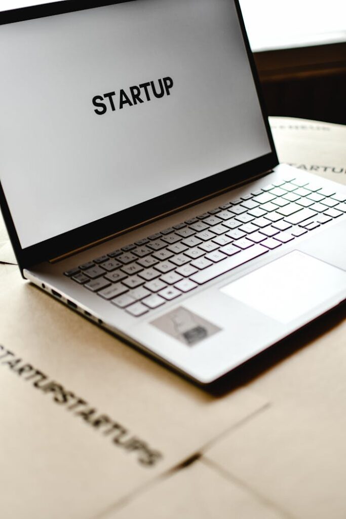 Modern laptop with startup text on screen, ideal for business themes.